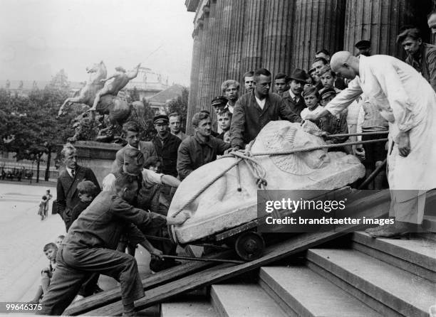 Lion sculpture moves round: At the steps of the Pergamon Museum. It's 2600 year old greek-archaic lion sculpture. Germany, Berlin. Photograph. 27....