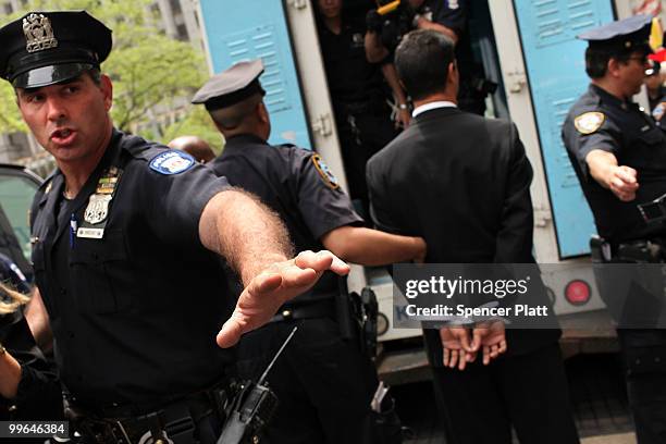 Man is lead into a police van during an act of civil disobedience to protest against the lack of an immigration reform bill on May 17, 2010 in New...