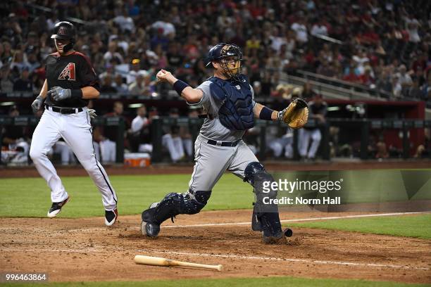 Ellis of the San Diego Padres gets a force out at home and throws the ball to first for a double play against the Arizona Diamondbacks at Chase Field...