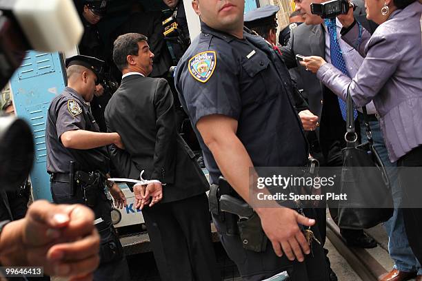 Man is lead into a police van during an act of civil disobedience to protest against the lack of an immigration reform bill on May 17, 2010 in New...