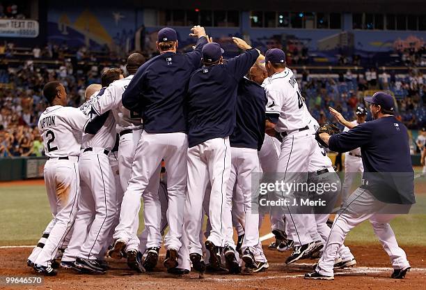 The Tampa Bay Rays celebrate their bottom of the ninth walk off home run victory over the Seattle Mariners at Tropicana Field on May 15, 2010 in St....