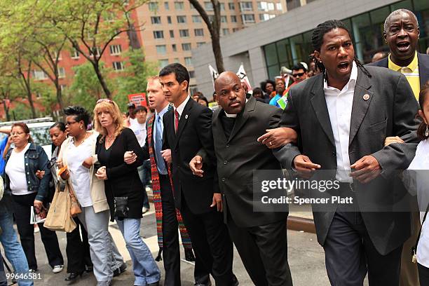 People block traffic during an act of civil disobedience to protest against the lack of an immigration reform bill on May 17, 2010 in New York City....