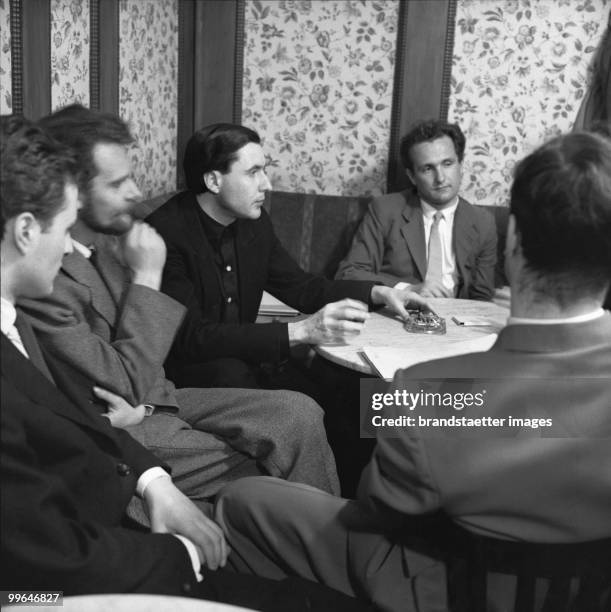 Konrad Bayer, H. C. Artmann, Gerhard Ruehm und Friedrich Achleitner in the legendary viennese coffeehouse Hawelka. Photograph. 1956.