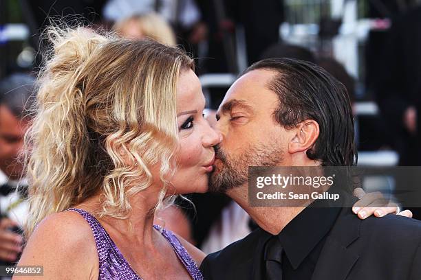 Former tennis player Henri Leconte kisses wife Florentine Leconte as they attend "Biutiful" Premiere at the Palais des Festivals during the 63rd...