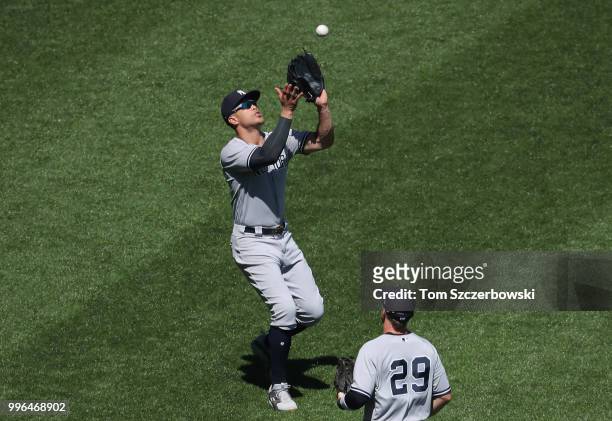 Giancarlo Stanton of the New York Yankees catches a fly ball in the ninth inning during MLB game action against the Toronto Blue Jays at Rogers...