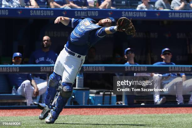 Russell Martin of the Toronto Blue Jays catches a foul pop up in the first inning during MLB game action against the New York Yankees at Rogers...