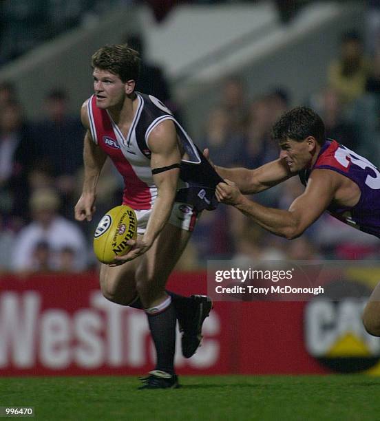 Robert Harvey of St Kilda is tackled by Ashley Prescott of Fremantle during the match between the Fremantle Dockers and St Kilda, during round Twelve...