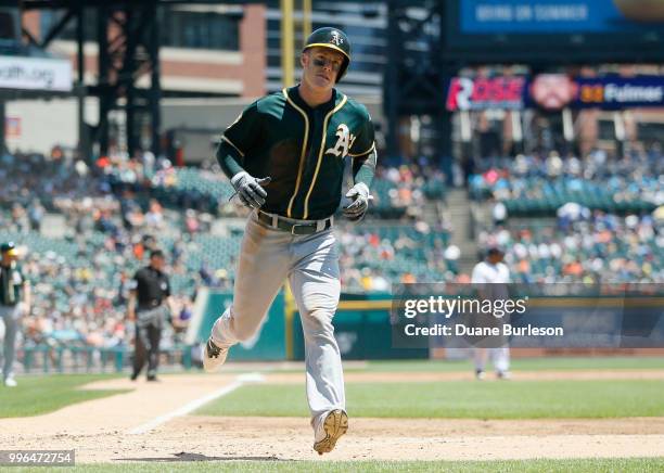 Mark Canha of the Oakland Athletics scores against the Detroit Tigers at Comerica Park on June 28, 2018 in Detroit, Michigan.
