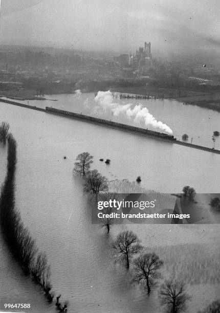 Flood waters near by the Ely cathedral. England. Photograph.