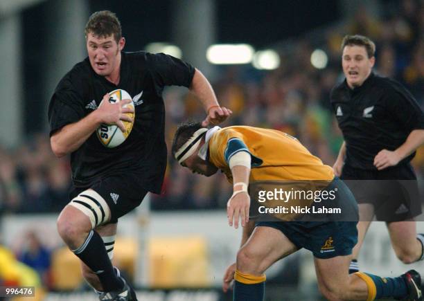 Chris Jack of the All Black's passes Nick Stiles of the Wallabies during the Tri Nations rugby union match between the Australian Wallabies and the...