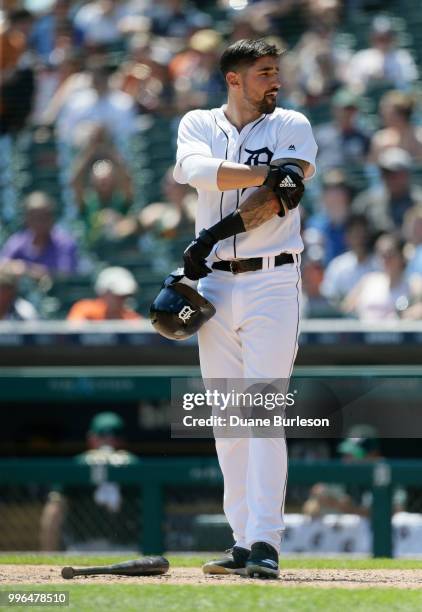 Nicholas Castellanos of the Detroit Tigers leaves his equipment after striking out against the Oakland Athletics at Comerica Park on June 28, 2018 in...