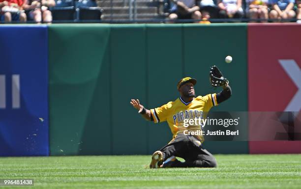 Starling Marte of the Pittsburgh Pirates makes a sliding catch on a ball hit by Carlos Santana of the Philadelphia Phillies in the fourth inning...