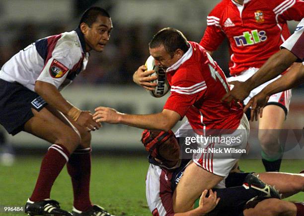 Steve Kefu and Elton Flatley of the Queensland Reds combine to tackle Rob Henderson of the British Lions during the match between the British Lions...