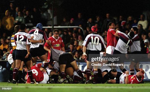 British Lions captain Martin Johnson confronts props Nic Stiles and Glenn Panoho of the Queensland Reds as a fight breaks out during the match...