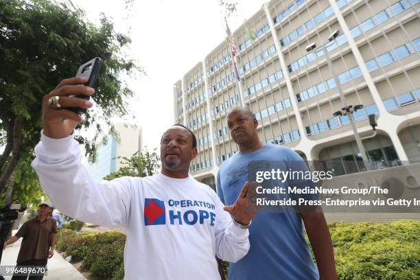 Najee Ali, with Operation Hope, conducts a Facebook live post with supporter Daryl Terrell, of Moreno Valley, demanding that San Bernardino County...