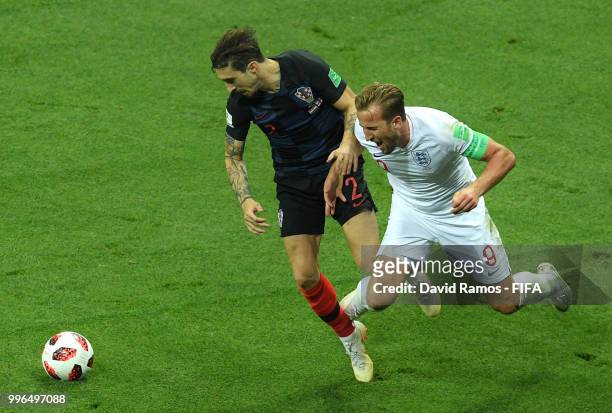 Harry Kane of England clashes with Lovre Kalinic of Croatia during the 2018 FIFA World Cup Russia Semi Final match between England and Croatia at...