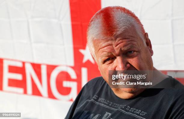 An England fan sits in front of a Union Flag as supporters gather to watch the World Cup semi-final match against Croatia on July 11, 2018 in...