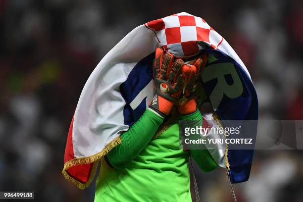 Croatia's goalkeeper Danijel Subasic celebrates at the end of the Russia 2018 World Cup semi-final football match between Croatia and England at the...