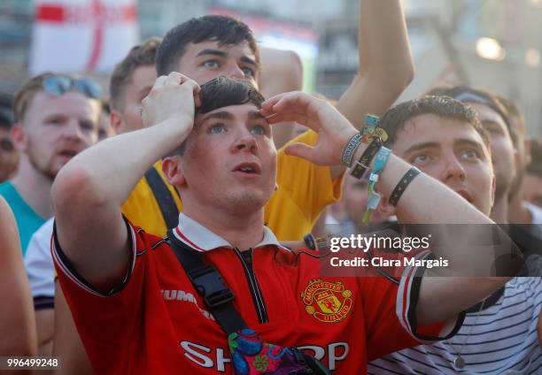 England fans react while watching the World Cup semi-final match against Croatia on a giant screen in an open air viewing area on July 11, 2018 in...