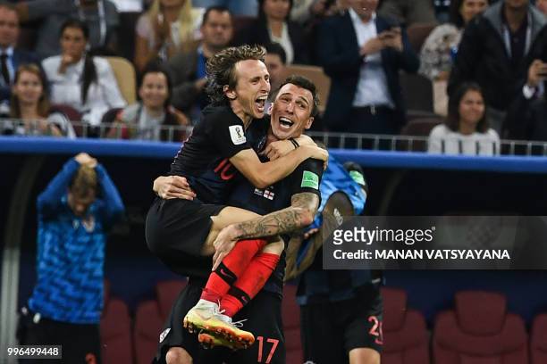 Croatia's midfielder Luka Modric and Croatia's forward Mario Mandzukic celebrate their win at the end of the Russia 2018 World Cup semi-final...