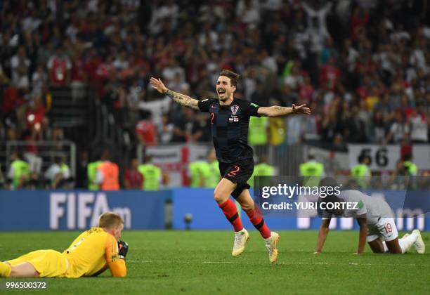 Croatia's defender Sime Vrsaljko celebrates past England's goalkeeper Jordan Pickford and England's forward Marcus Rashford at the end of the Russia...