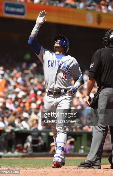 Javier Baez of the Chicago Cubs reacts as he crosses home plate after hitting a home run in the seventh inning against the San Francisco Giants at...