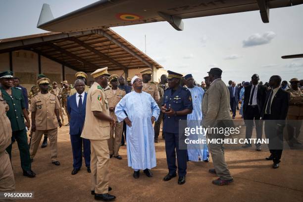 Malian President Ibrahim Boubacar Keita looks up as he attends the presentation of four new turboprop light attack aircrafts "Super Tucano" at the...