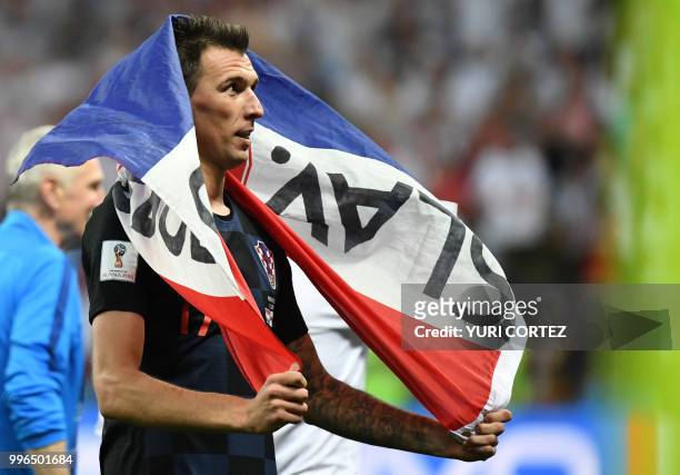 Croatia's forward Mario Mandzukic celebrates at the end of the Russia 2018 World Cup semi-final football match between Croatia and England at the...