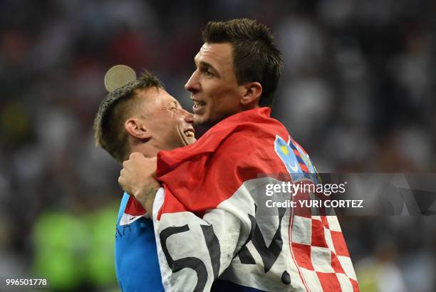 Croatia's forward Mario Mandzukic celebrates with assistant coach Ivica Olic at the end of the Russia 2018 World Cup semi-final football match...