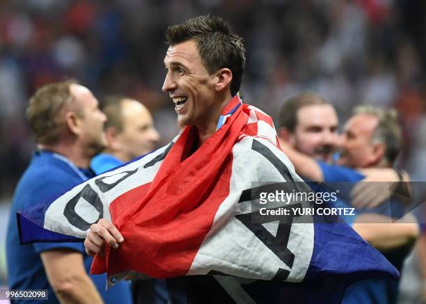 Croatia's forward Mario Mandzukic celebrates at the end of the Russia 2018 World Cup semi-final football match between Croatia and England at the...