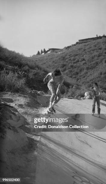 Skateboarder John Turbiville rides at "The Channell" in the Hollywood Hills area on June 20, 1976 in Los Angeles, California.