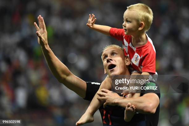 Croatia's defender Domagoj Vida celebrates with his son David at the end of the Russia 2018 World Cup semi-final football match between Croatia and...