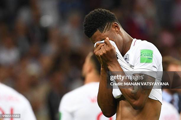 England's forward Marcus Rashford reacts after the Russia 2018 World Cup semi-final football match between Croatia and England at the Luzhniki...