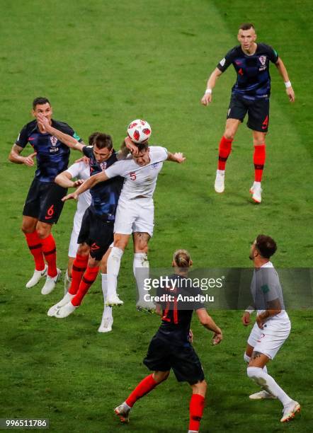 Vida , Dejan Lovren and Ivan Perisic of Croatia in action against John Stones of England during the 2018 FIFA World Cup Russia Semi Final match...