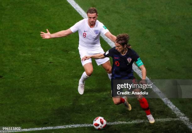 Luka Modric of Croatia in action against Jordan Henderson of England during the 2018 FIFA World Cup Russia Semi Final match between England and...