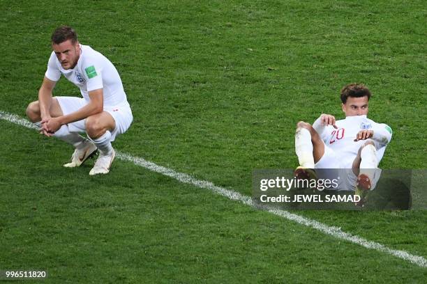 England's midfielder Jordan Henderson and England's midfielder Dele Alli react after losing the Russia 2018 World Cup semi-final football match...