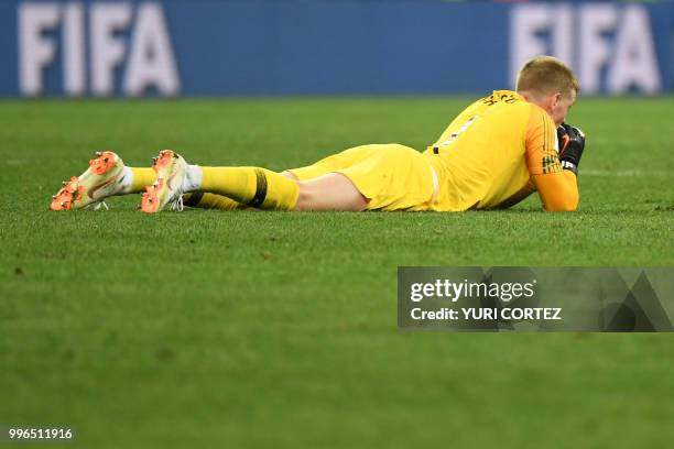 England's goalkeeper Jordan Pickford reacts at the end of the Russia 2018 World Cup semi-final football match between Croatia and England at the...