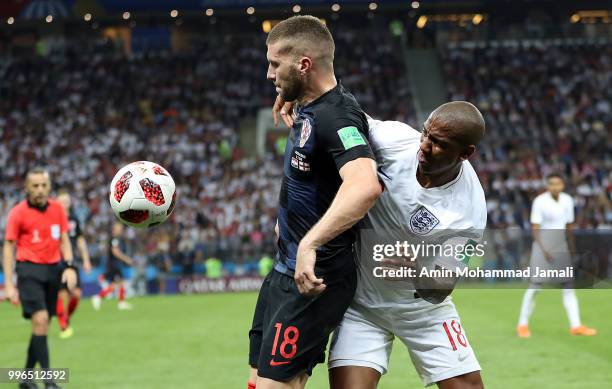 Ante Rebic of Croatia and Ashly Young of England in action during the 2018 FIFA World Cup Russia Semi Final match between England and Croatia at...