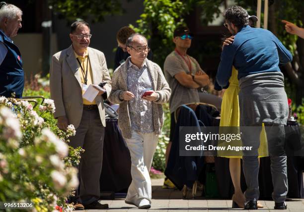 At center, Masayoshi Son chief executive officer of SoftBank, attends the annual Allen & Company Sun Valley Conference, July 11, 2018 in Sun Valley,...