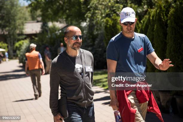Dara Khosrowshahi, chief executive officer of Uber, walks with Ian Smith, managing director at Allen & Company, as they attend annual Allen & Company...