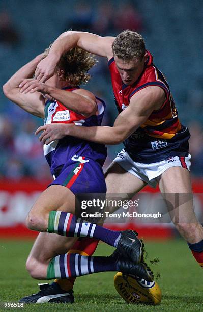 Shaun McManus of the Fremantle Dockers is tackled by Simon Goodwin of the Adelaide Crows during round 22 AFL match between the Fremantle Dockers and...