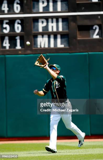 Stephen Piscotty of the Oakland Athletics fields during the game against the Los Angeles Angels of Anaheim at the Oakland Alameda Coliseum on June...