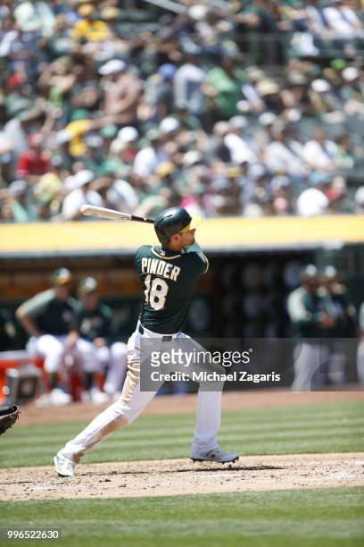 Chad Pinder of the Oakland Athletics hits a home run during the game against the Los Angeles Angels of Anaheim at the Oakland Alameda Coliseum on...