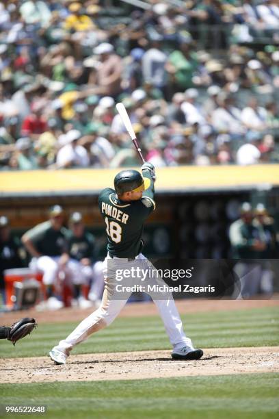 Chad Pinder of the Oakland Athletics hits a home run during the game against the Los Angeles Angels of Anaheim at the Oakland Alameda Coliseum on...