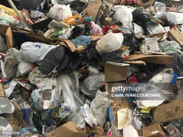 Waste lies in a pile at the District of Columbias Fort Totten Transfer Station in Washington, DC, on July 10, 2018 - Since China, the top global...