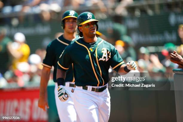 Khris Davis of the Oakland Athletics heads to the dugout during the game against the Los Angeles Angels of Anaheim at the Oakland Alameda Coliseum on...