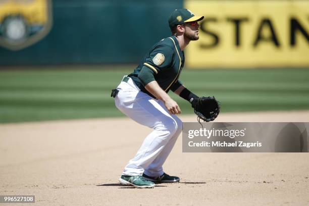 Jed Lowrie of the Oakland Athletics fields during the game against the Los Angeles Angels of Anaheim at the Oakland Alameda Coliseum on June 16, 2018...