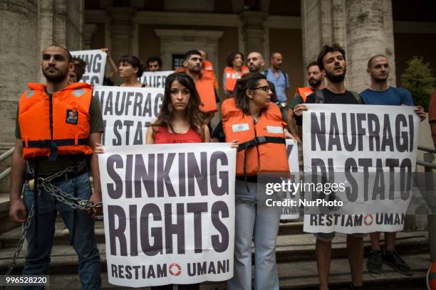 'Stay Human' activists stage a protest outside the Ministry of Transport in Rome, on July 11, 2018. Dozens of 'We remain human' network activists...