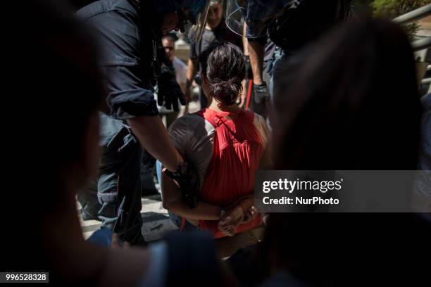 Protester is dragged away by Italian police outside the Ministry of Transport in Rome, on July 11, 2018. Dozens of 'We remain human' network...