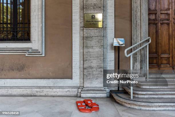 Lifejacket stands on the ground in front of the Italian Minister of Infrastructures and Transports after 'We remain human' network activists chained...